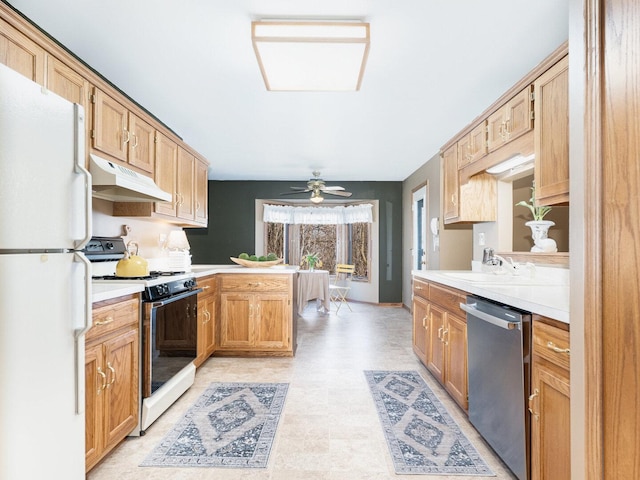 kitchen featuring white appliances, a peninsula, a sink, light countertops, and under cabinet range hood