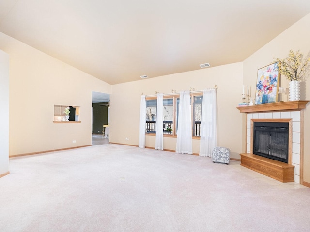 unfurnished living room featuring visible vents, carpet, a fireplace, baseboards, and vaulted ceiling