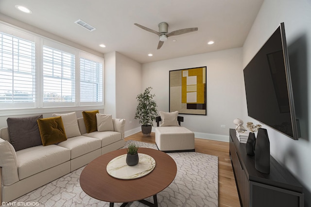 living room featuring recessed lighting, visible vents, ceiling fan, light wood-type flooring, and baseboards