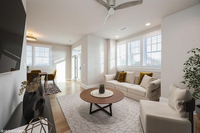 living room featuring recessed lighting, visible vents, light wood-style floors, a ceiling fan, and baseboards