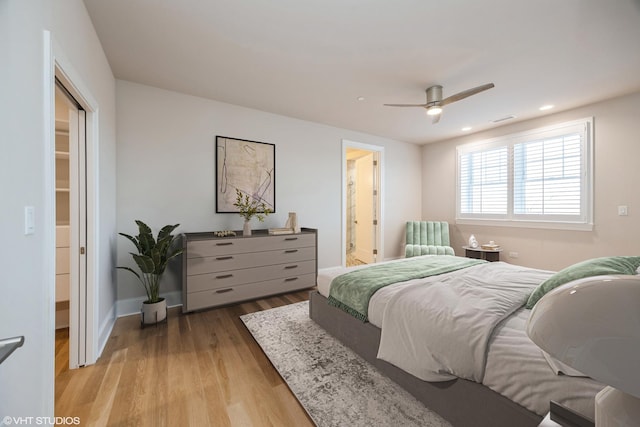 bedroom featuring recessed lighting, visible vents, light wood-style flooring, ensuite bath, and baseboards