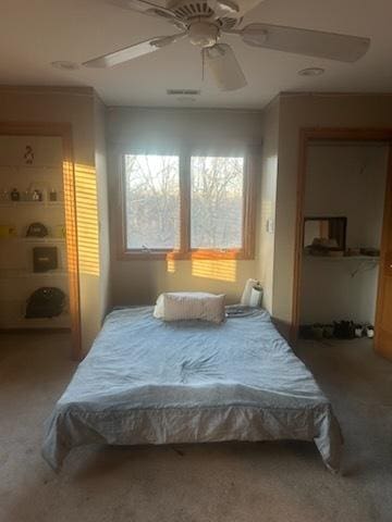 carpeted bedroom featuring a closet and a ceiling fan