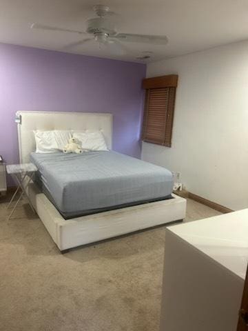 bedroom featuring light colored carpet and ceiling fan