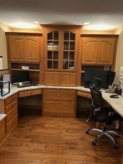 office space featuring built in desk and wood finished floors