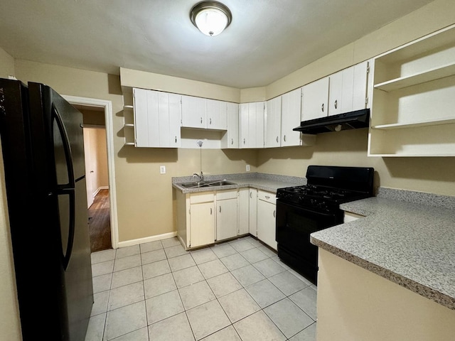 kitchen featuring light tile patterned floors, under cabinet range hood, black appliances, open shelves, and a sink