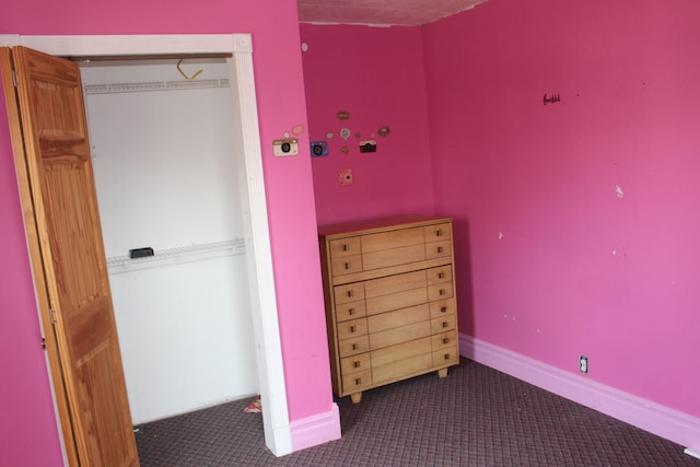 unfurnished bedroom featuring baseboards and carpet floors