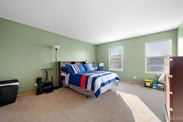 bedroom featuring carpet floors and baseboards