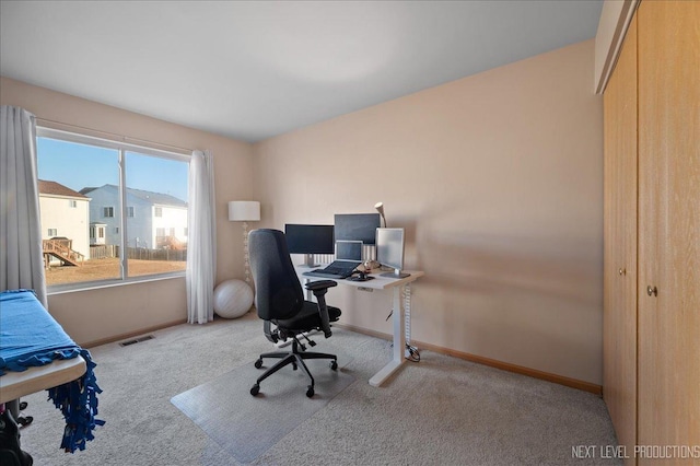 office space with carpet, visible vents, and baseboards