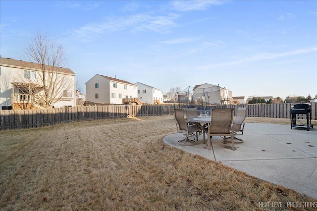 view of yard with a fenced backyard, a residential view, and a patio