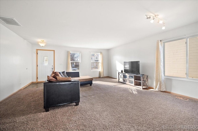 carpeted living area with visible vents and baseboards