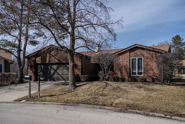 view of front facade featuring brick siding, driveway, a front yard, and a garage