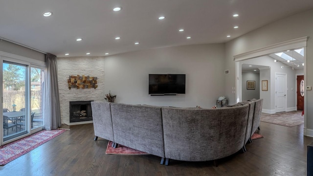 living room with recessed lighting, dark wood finished floors, and a fireplace