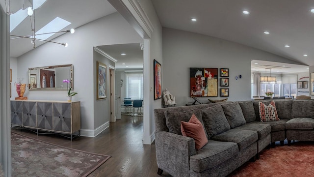 living area featuring recessed lighting, vaulted ceiling with skylight, baseboards, and wood finished floors