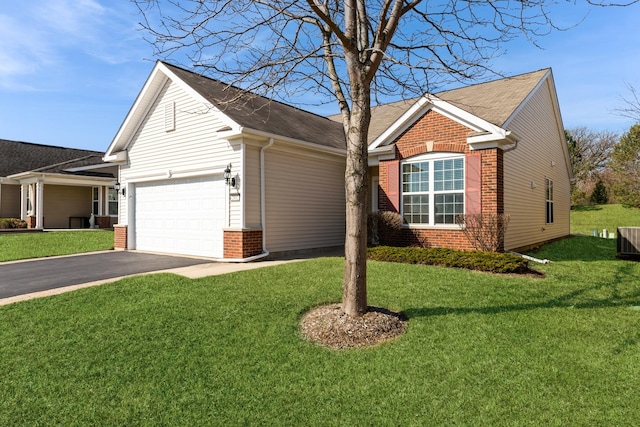 ranch-style home featuring a front yard, brick siding, an attached garage, and driveway