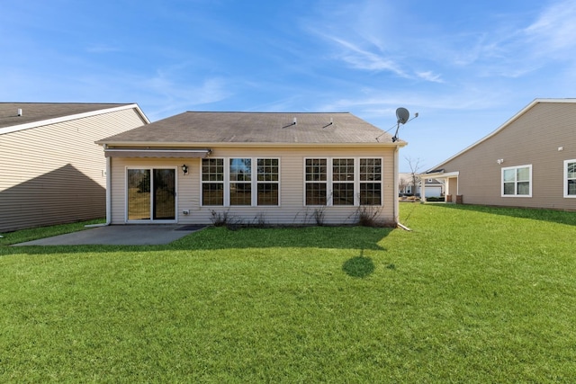 rear view of house featuring a patio area and a lawn