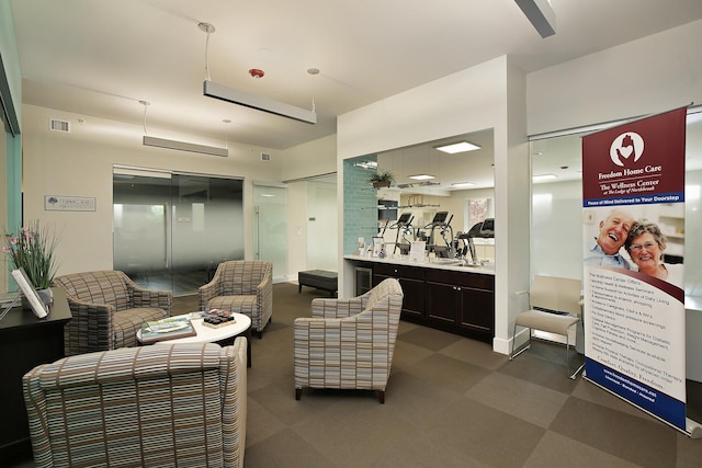 living room with visible vents and dark floors