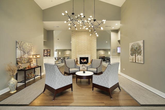 interior space featuring an inviting chandelier, wood finished floors, and high vaulted ceiling