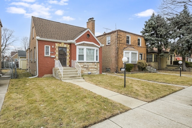 bungalow-style house featuring brick siding, fence, a gate, a front lawn, and a chimney