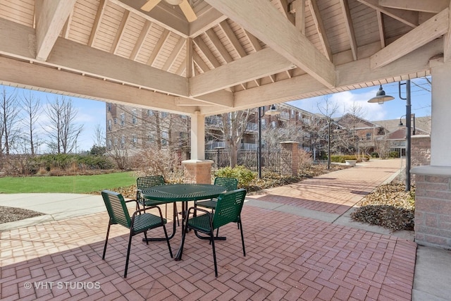 view of patio / terrace with a gazebo, outdoor dining area, and fence