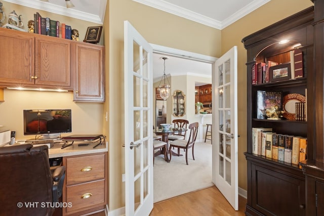 office featuring french doors, a notable chandelier, ornamental molding, and light wood-style flooring