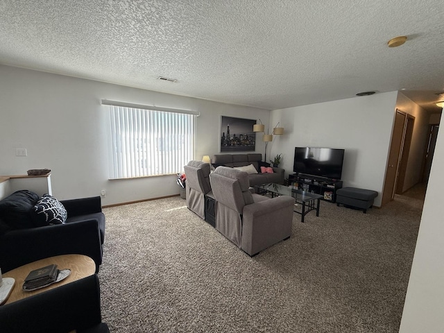 living area with carpet, visible vents, and a textured ceiling