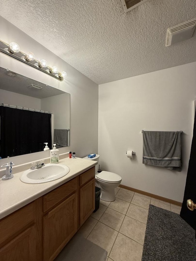 bathroom featuring toilet, tile patterned flooring, visible vents, and a textured ceiling