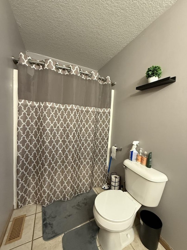 bathroom featuring curtained shower, visible vents, toilet, a textured ceiling, and tile patterned flooring