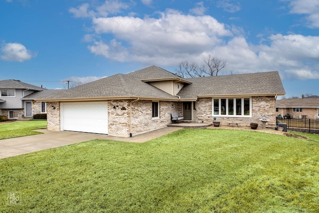 split level home with a shingled roof, an attached garage, fence, driveway, and a front lawn