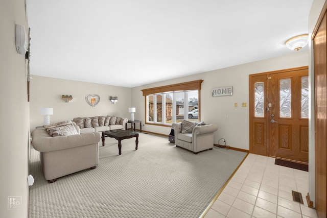 living area featuring visible vents, baseboards, and light tile patterned floors