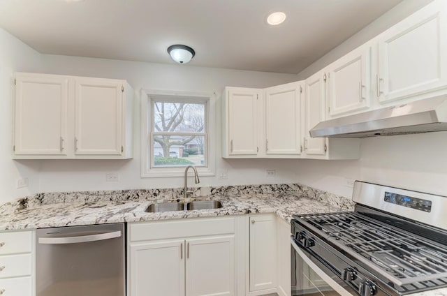 kitchen featuring under cabinet range hood, a sink, white cabinets, appliances with stainless steel finishes, and light stone countertops