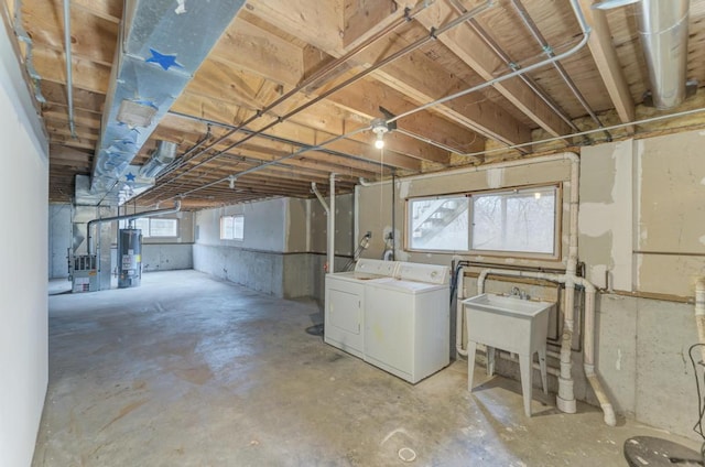 basement featuring gas water heater and independent washer and dryer