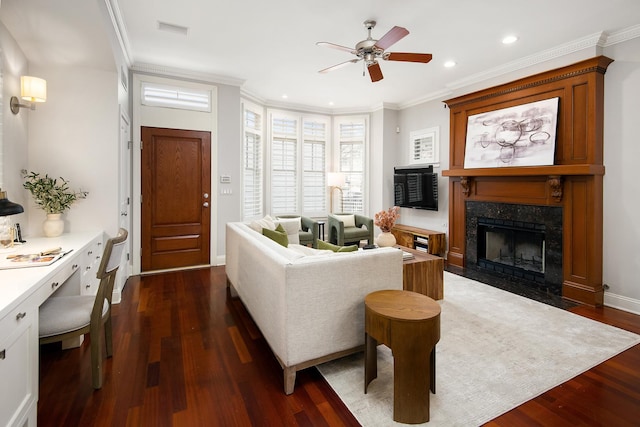 living area featuring crown molding, a fireplace, recessed lighting, visible vents, and dark wood-type flooring