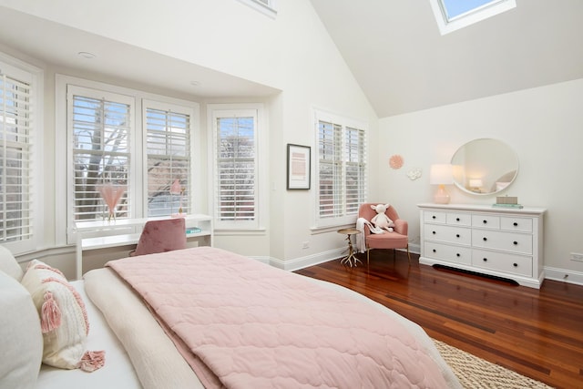 bedroom with high vaulted ceiling, a skylight, baseboards, and wood finished floors