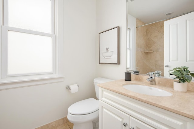 bathroom featuring a shower, tile patterned flooring, vanity, and toilet