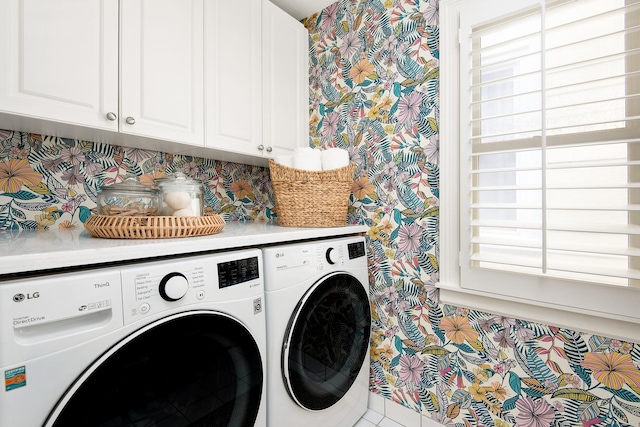 laundry area featuring independent washer and dryer and cabinet space