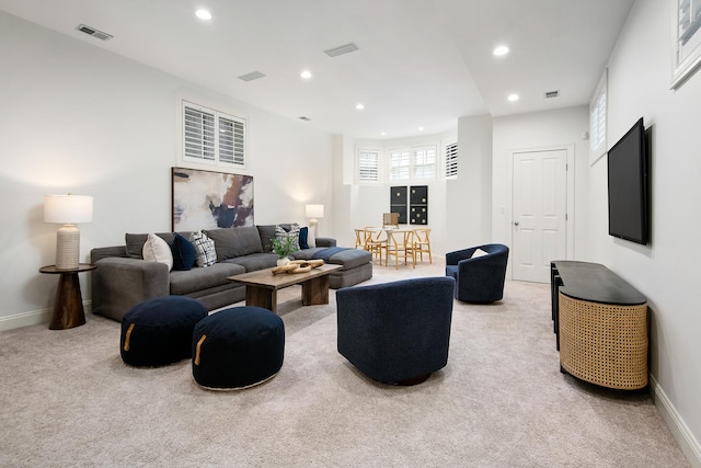 carpeted living area featuring recessed lighting, visible vents, and baseboards