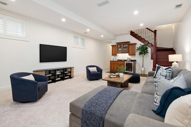 living area featuring wine cooler, recessed lighting, visible vents, light carpet, and wet bar