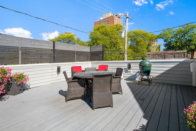 wooden terrace featuring outdoor dining area