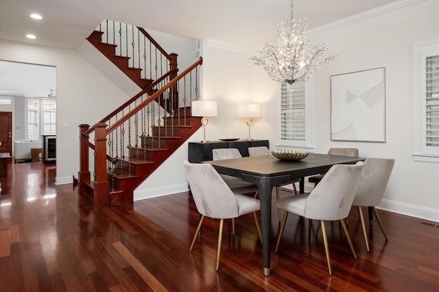 dining area featuring an inviting chandelier, wood finished floors, baseboards, and stairs