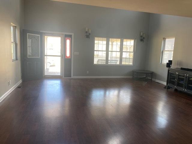 foyer entrance featuring dark wood-type flooring and baseboards