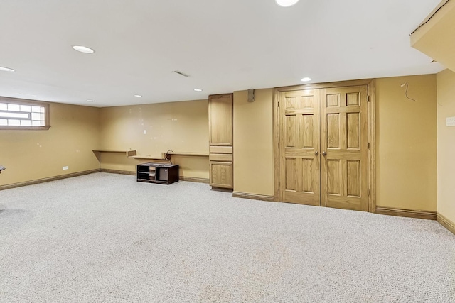 below grade area featuring carpet floors, recessed lighting, and baseboards