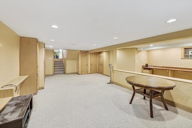 interior space featuring light carpet, baseboards, and recessed lighting