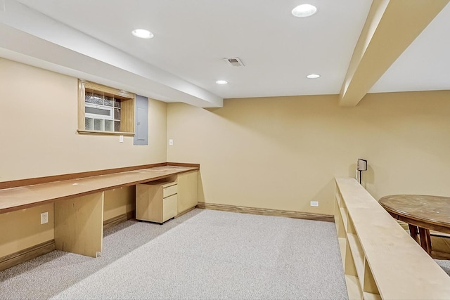 carpeted office space featuring recessed lighting, visible vents, baseboards, electric panel, and built in desk