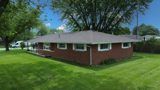 1978 Fleming St, Watseka, IL 60970 - view of property exterior with a lawn, brick siding, and roof with shingles
