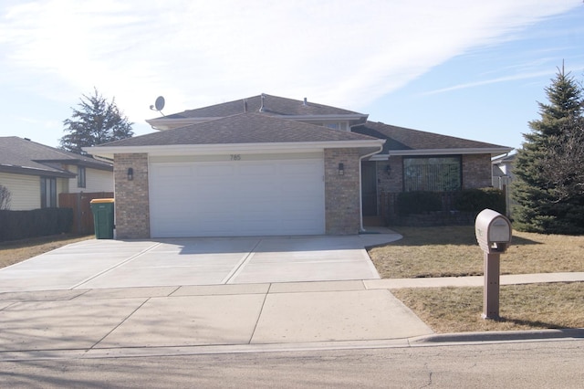 view of front of home with brick siding, a shingled roof, concrete driveway, an attached garage, and a front yard