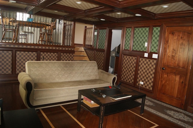 living room featuring beam ceiling, coffered ceiling, and wood finished floors