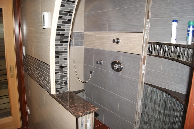 full bath featuring tiled shower