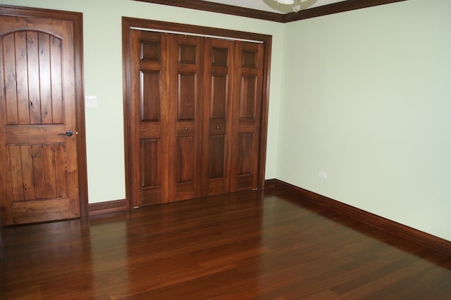 unfurnished bedroom featuring baseboards and wood finished floors