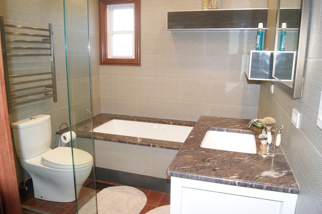 bathroom featuring tiled shower, toilet, radiator heating unit, vanity, and tile walls