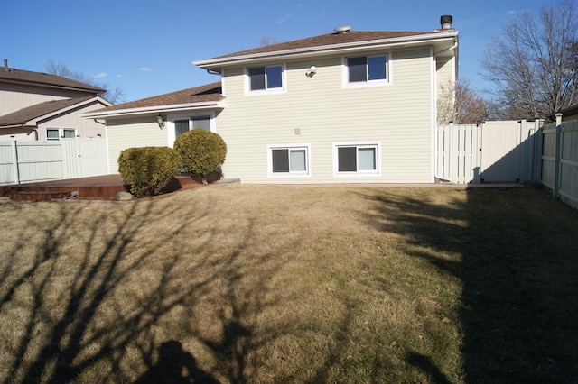 rear view of house featuring a gate, a lawn, a patio, and fence